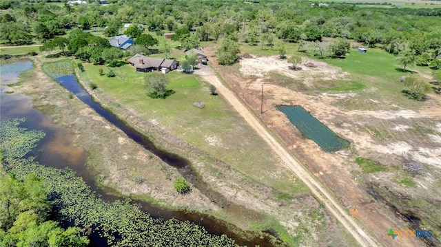 aerial view featuring a water view, a view of trees, and a rural view