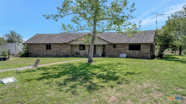 ranch-style house featuring brick siding and a front lawn