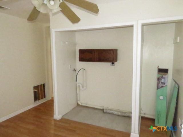 bathroom with ceiling fan and wood-type flooring