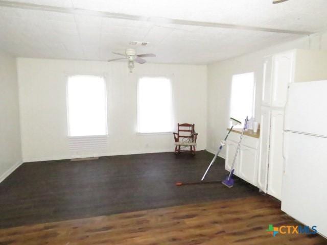 spare room featuring ceiling fan and dark wood-type flooring