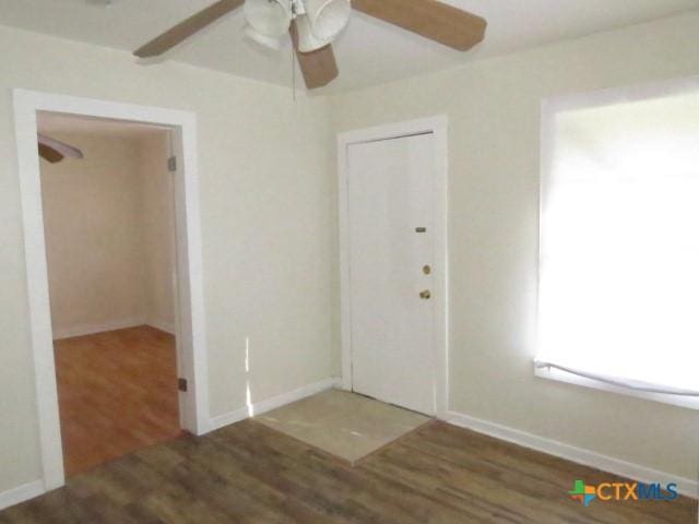 empty room with dark hardwood / wood-style floors