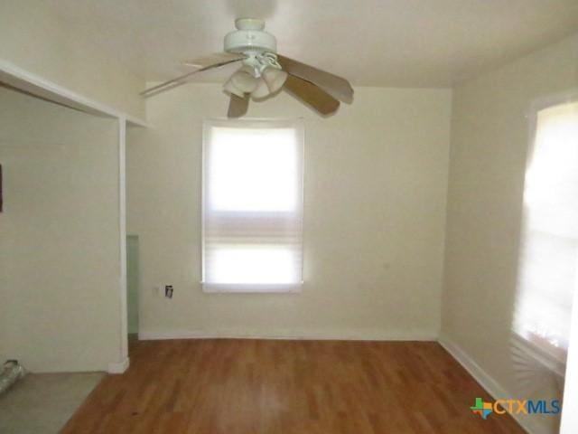 empty room featuring ceiling fan and hardwood / wood-style flooring