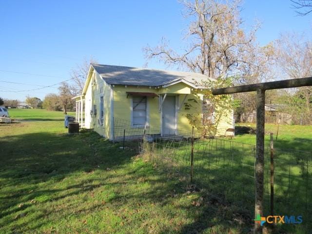 view of side of home featuring a yard