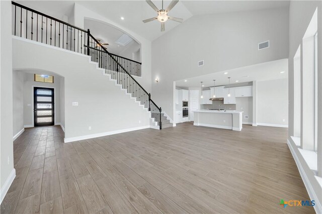 kitchen featuring white cabinets, hardwood / wood-style floors, a center island, and tasteful backsplash