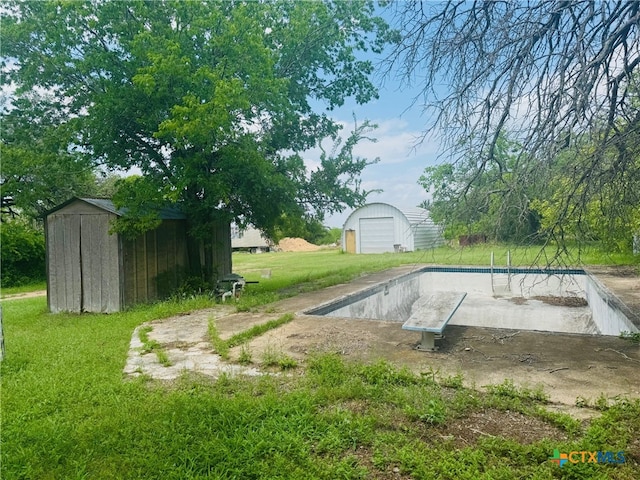 exterior space with a storage shed, a detached garage, and an outbuilding