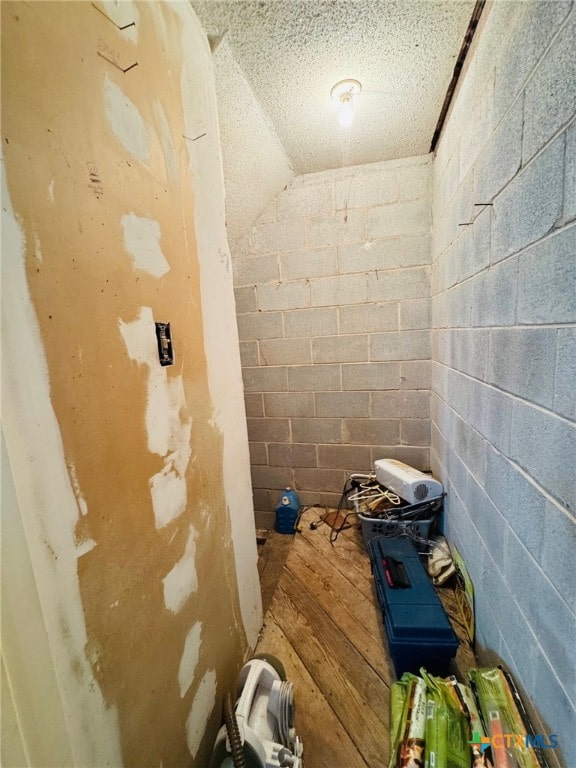 bathroom featuring a textured ceiling and hardwood / wood-style floors