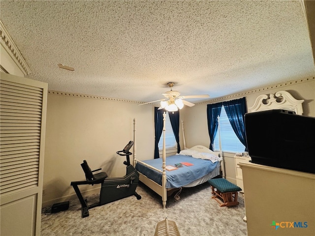 bedroom with a textured ceiling, light carpet, and ceiling fan