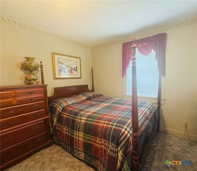 bedroom featuring light carpet and a textured ceiling