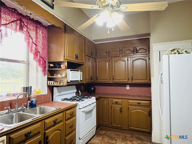 kitchen featuring brown cabinets, ceiling fan, open shelves, a sink, and white appliances