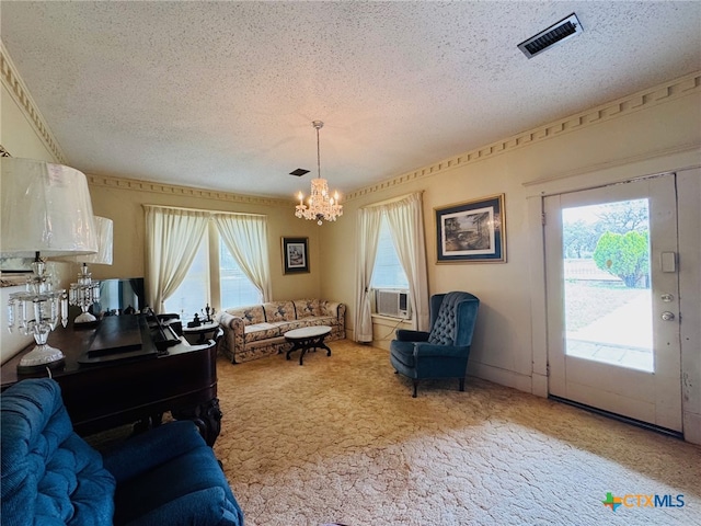 living room featuring a wealth of natural light, visible vents, a textured ceiling, and a notable chandelier