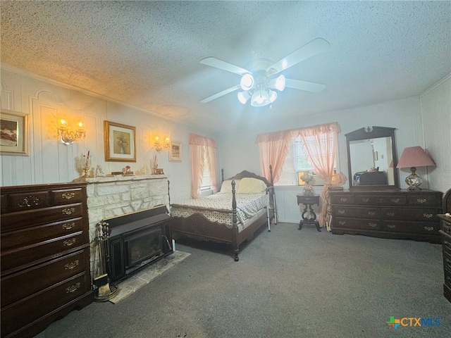 carpeted bedroom with a textured ceiling, ceiling fan, and a fireplace