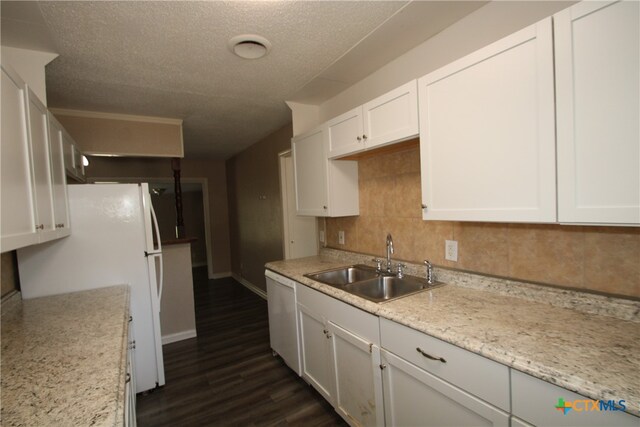 kitchen featuring white cabinetry, dark hardwood / wood-style floors, white dishwasher, decorative backsplash, and sink