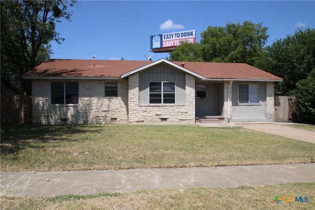 ranch-style home with a front lawn