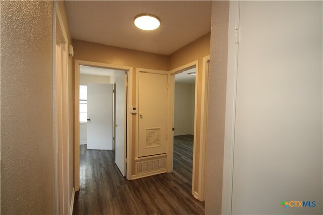 corridor featuring dark hardwood / wood-style flooring