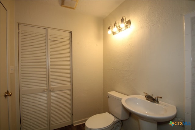 bathroom with sink and toilet