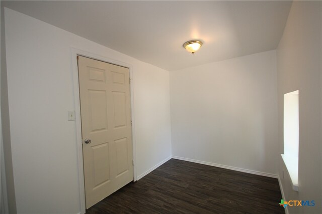 empty room featuring dark wood-type flooring