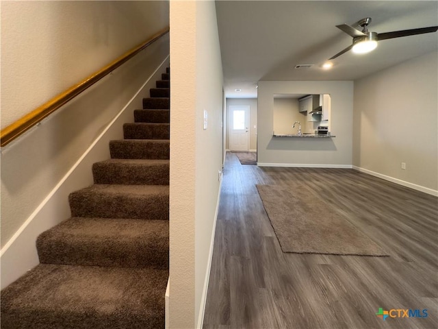 staircase with visible vents, baseboards, wood finished floors, and a ceiling fan