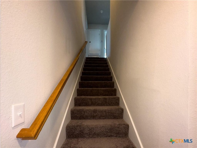 stairway with a textured wall
