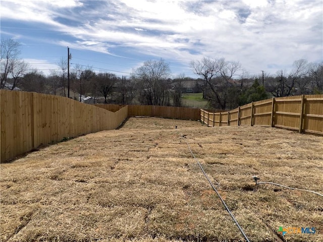 view of yard with a fenced backyard