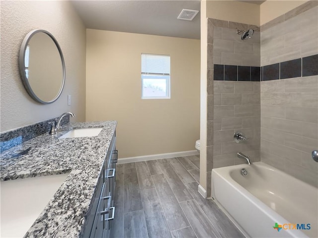full bath with visible vents, baseboards, wood finish floors, toilet, and a sink