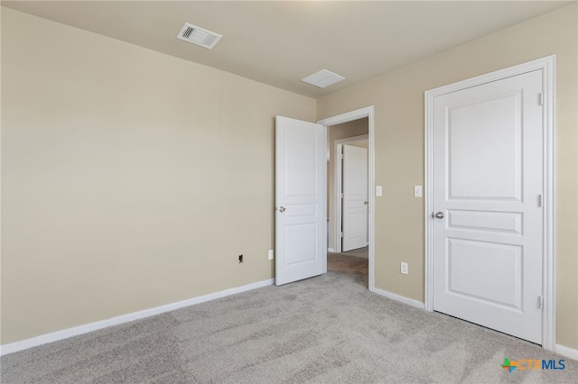 unfurnished bedroom featuring light colored carpet