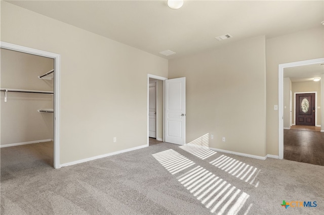 13512 Kearns Dr, Pflugerville, TX 78660 - unfurnished bedroom featuring carpet, a walk in closet, and baseboards