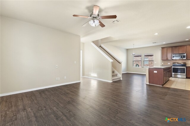 13512 Kearns Dr, Pflugerville, TX 78660 - unfurnished living room featuring wood finished floors, stairway, a ceiling fan, recessed lighting, and baseboards
