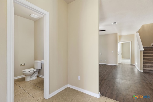 13512 Kearns Dr, Pflugerville, TX 78660 - corridor featuring stairs, tile patterned floors, and baseboards