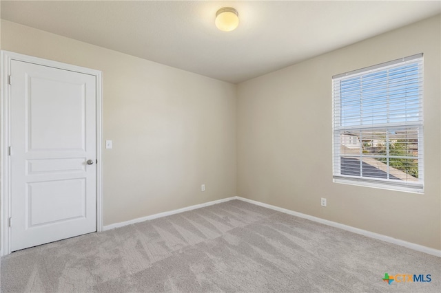 unfurnished room with light carpet