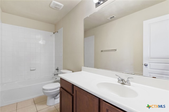 full bathroom featuring toilet, tiled shower / bath combo, vanity, and tile patterned floors