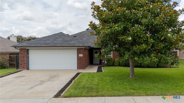 2207 Merle Dr, Copperas Cove, TX 76522 - ranch-style home featuring an attached garage, brick siding, concrete driveway, and a front lawn