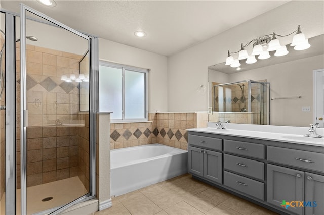 2207 Merle Dr, Copperas Cove, TX 76522 - bathroom with tile patterned flooring, double vanity, a bath, a stall shower, and recessed lighting