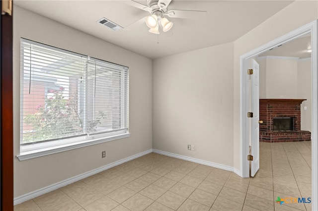 2207 Merle Dr, Copperas Cove, TX 76522 - unfurnished room with a ceiling fan, a brick fireplace, and light tile patterned flooring