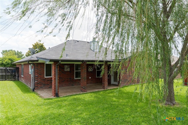 2207 Merle Dr, Copperas Cove, TX 76522 - rear view of house with brick siding, a patio, and a chimney