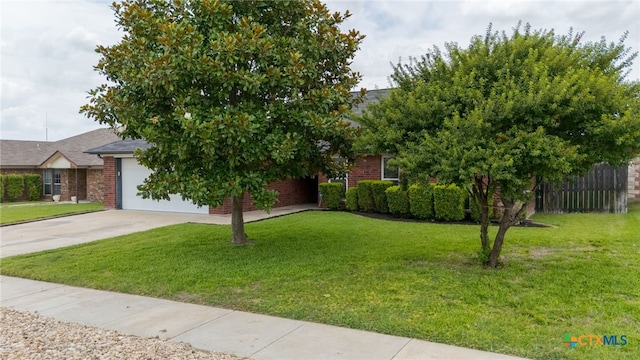 2207 Merle Dr, Copperas Cove, TX 76522 - obstructed view of property featuring concrete driveway, a garage, and brick siding