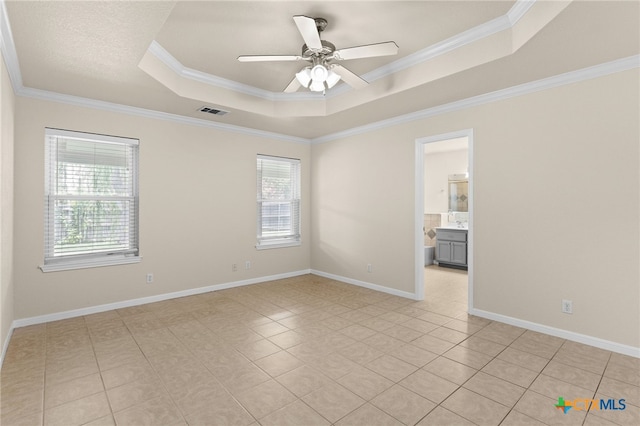 2207 Merle Dr, Copperas Cove, TX 76522 - empty room featuring a tray ceiling, plenty of natural light, a ceiling fan, ornamental molding, and light tile patterned floors