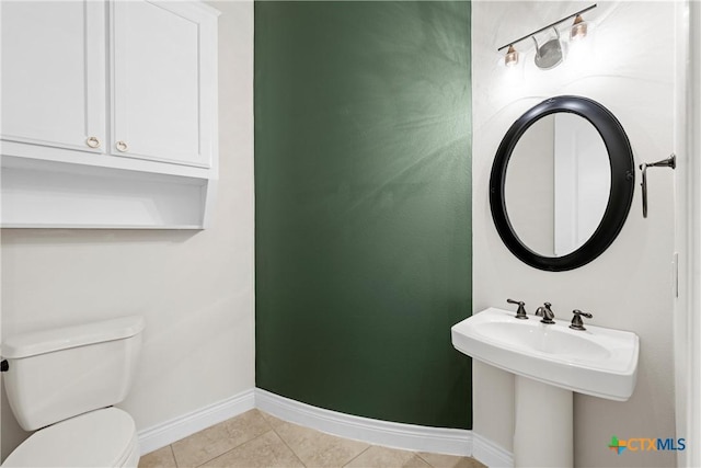 bathroom with tile patterned flooring, toilet, and sink