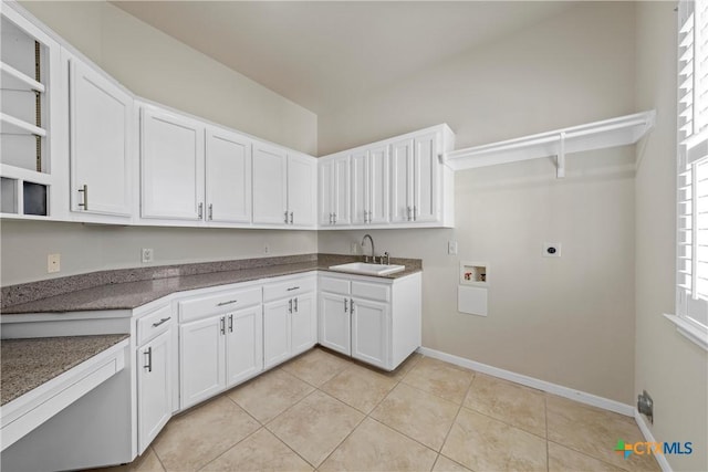 laundry room with light tile patterned floors, hookup for an electric dryer, washer hookup, a sink, and baseboards