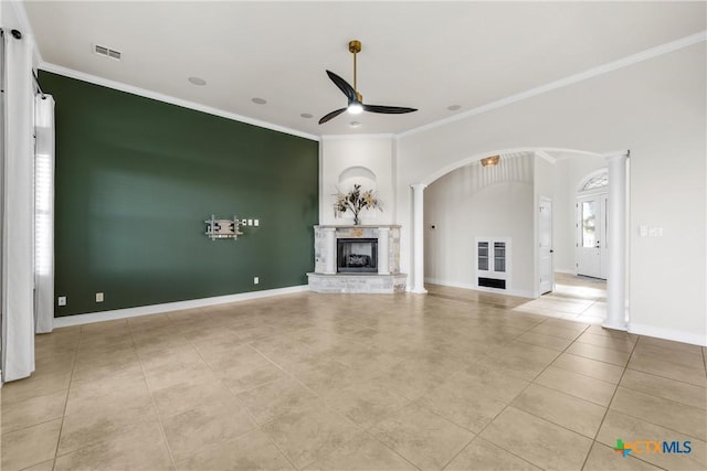 unfurnished living room featuring ornate columns, ceiling fan, light tile patterned floors, and ornamental molding