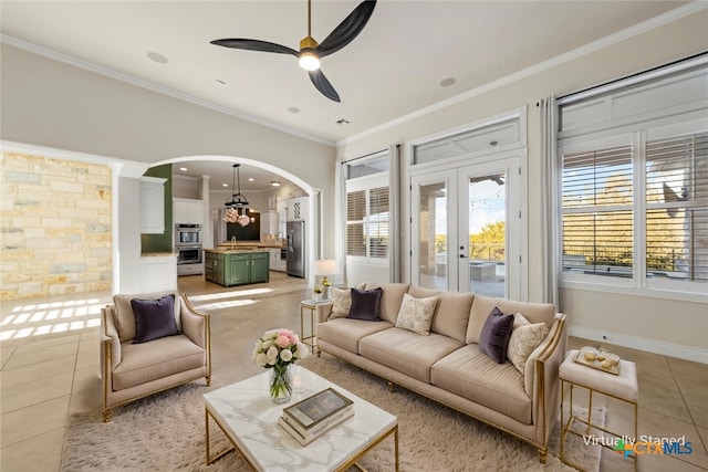 tiled living room featuring sink, french doors, ceiling fan, and ornamental molding