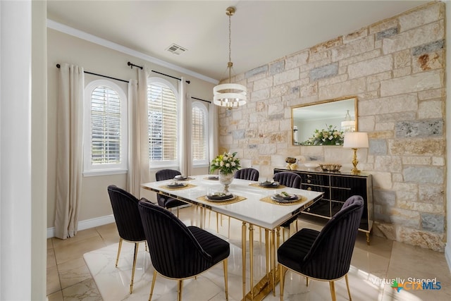 dining room featuring ornamental molding, visible vents, and baseboards