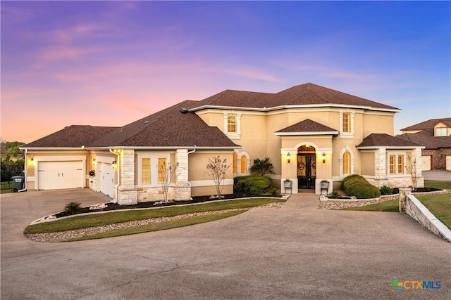 view of front of house featuring aphalt driveway, stone siding, a shingled roof, and stucco siding