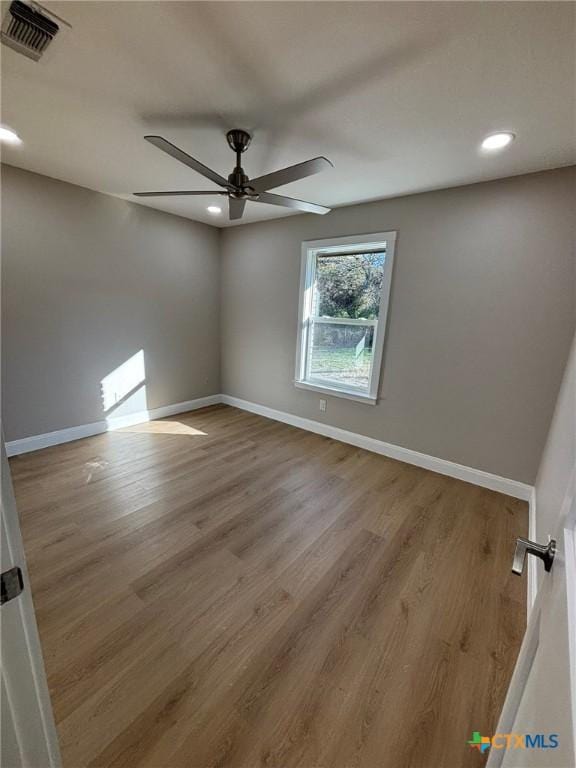 unfurnished room with light wood-type flooring and ceiling fan