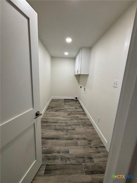 laundry area with cabinets, hookup for a washing machine, and hookup for an electric dryer