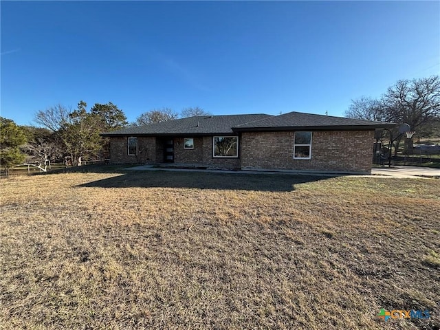 back of property featuring a yard