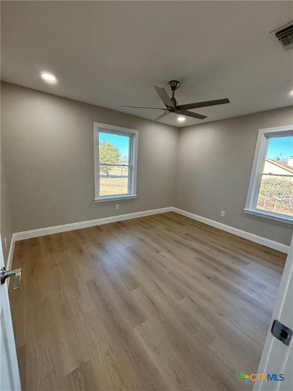 spare room with light hardwood / wood-style floors and ceiling fan