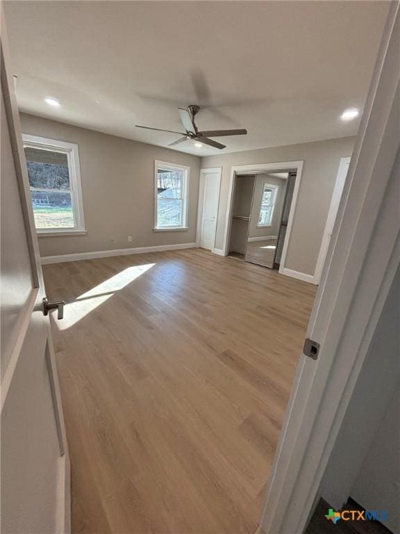 unfurnished room featuring a healthy amount of sunlight and light hardwood / wood-style floors