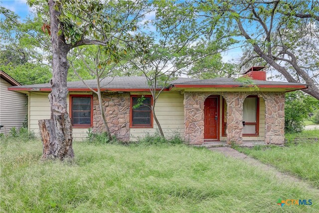 ranch-style house with a front lawn