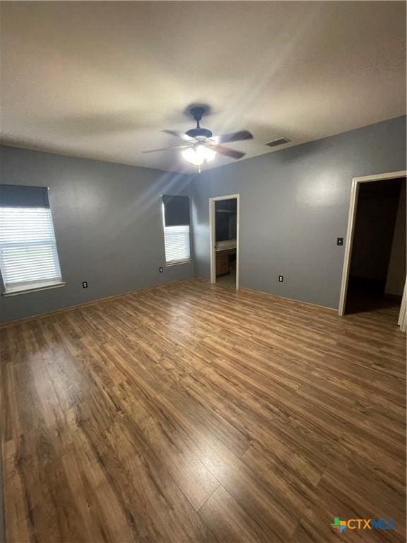 unfurnished bedroom with ceiling fan and hardwood / wood-style floors