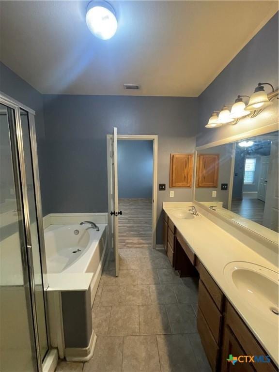 bathroom featuring vanity and separate shower and tub